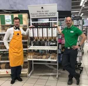 Två personer bredvid dispenser med popcornkärnor på Coop i Arvika